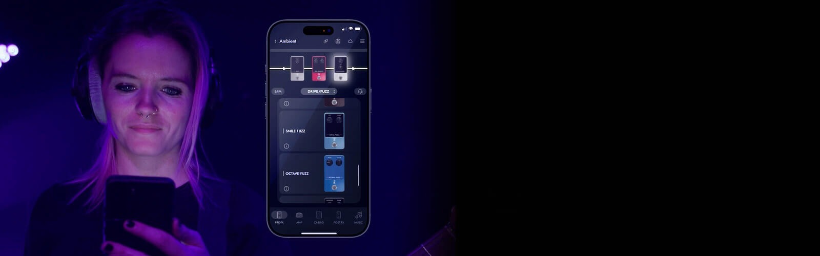 Musician using a smartphone with a dark interface in a dimly lit setting