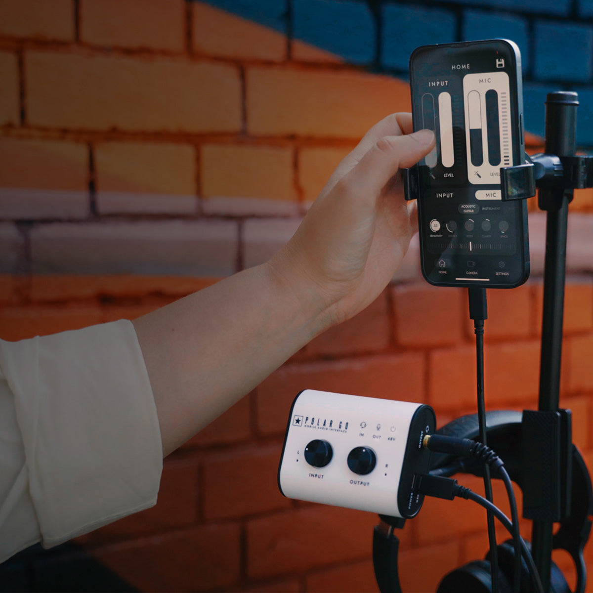 Blackstar Polar GO pocket studio mounted on a stand with a hand editing an audio interface app on a phone